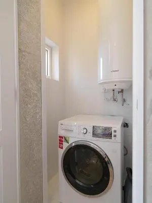 a washer and dryer in a small bathroom at Oporto Medusa Apartment in Porto