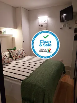 a sign for a clean and safe room with a bed at Porto Belo Clérigos in Porto
