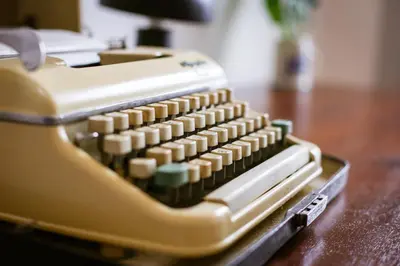 an old computer keyboard sitting on a wooden table at Casa do Poeta & Guitarra by PCH in Porto