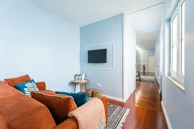 a living room with a couch and a tv at Victoria Project - Apartments - Private Parking in Porto