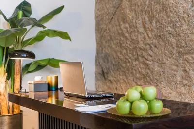 a desk with a laptop and a plate of fruit at Victoria Project - Apartments - Private Parking in Porto