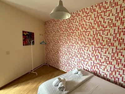 a bedroom with a red and white brick wall at Peter Residence - Rio Douro & Caves Vinho do Porto in Vila Nova de Gaia