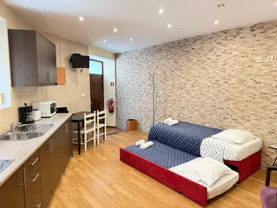 a kitchen with a couch in a room at Peter Residence - Rio Douro & Caves Vinho do Porto in Vila Nova de Gaia