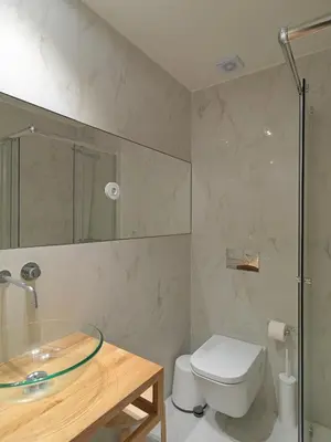 a bathroom with a toilet and a glass sink at FLH Porto Central Apartment in Porto
