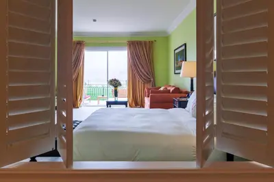 a bedroom with green walls and a bed and a window at The Yeatman in Vila Nova de Gaia