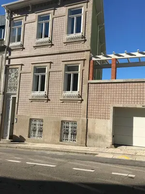 a brick building with barred windows on a street at Secret Camões in Porto