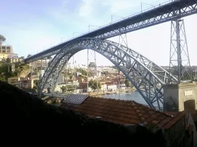 a bridge over a river with a city at Portus Ribeira House in Vila Nova de Gaia