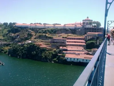 a bridge over the river with a city in the background at Portus Ribeira House in Vila Nova de Gaia