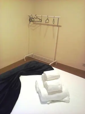 a pile of towels on a bed in a room at Portus Ribeira House in Vila Nova de Gaia