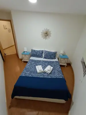 a bedroom with a bed with two towels on it at Portus Ribeira House in Vila Nova de Gaia