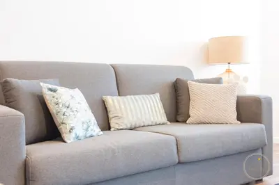 a couch with pillows on it in a living room at Oporto Ceuta Residences - Residence 8 by We Do Living in Porto