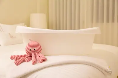 a pink stuffed octopus sitting on top of a bed at Oporto Ceuta Residences - Residence 8 by We Do Living in Porto