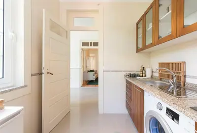a kitchen with a sink and a washing machine at Tripas-Coração, Breiner GreenHouse in Porto