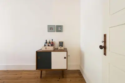 a small table in a room with a white wall at Tripas-Coração, Breiner GreenHouse in Porto