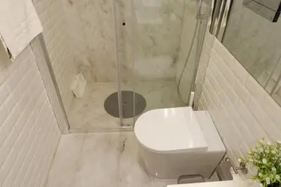 a bathroom with a shower with a toilet and a shower at Porto Urban Art Trindade in Porto