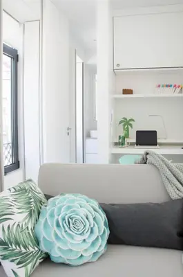 a living room with a couch with a flower pillow at Porto Moments Apartments by Portugal Collection in Vila Nova de Gaia