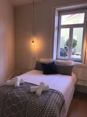a bedroom with a large bed with towels on it at Terrace Camões in Porto