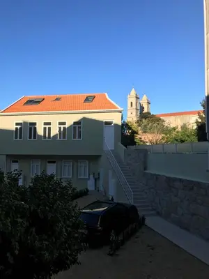 a car parked in front of a building at Terrace Camões in Porto