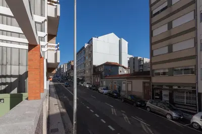 a view of a city street with buildings and cars at Terrace Camões in Porto