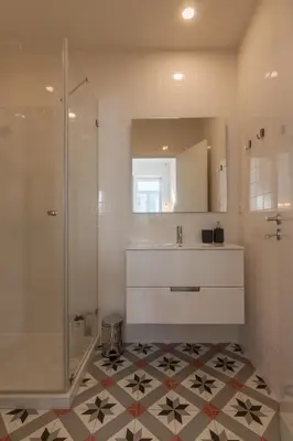 a bathroom with a shower and a sink and a mirror at Terrace Camões in Porto
