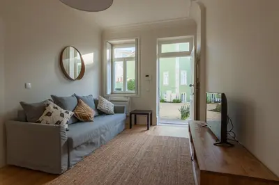 a living room with a couch and a mirror at Terrace Camões in Porto
