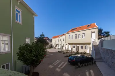 a car parked in a parking lot between two buildings at Terrace Camões in Porto