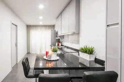 a kitchen with a table and chairs in a room at Camarinha Oporto Apartments in Porto
