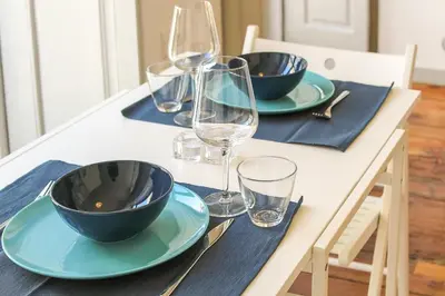 a table with two bowls and wine glasses on it at Bonjardim Flats - T1 com varanda in Porto