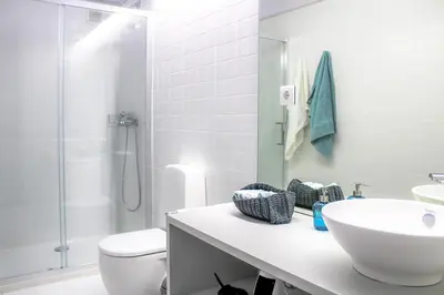 a bathroom with a sink and a toilet and a shower at Bonjardim Flats - T2 com Varanda in Porto