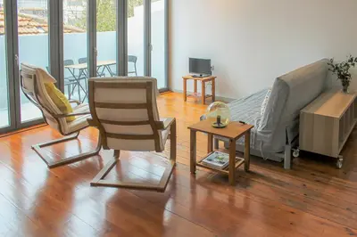 a living room with a couch and chairs and a table at Bonjardim Flats - T2 com Varanda in Porto