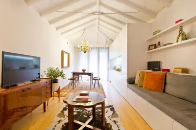a living room with a couch and a tv at Porto Emotions - Caldeireiros in Porto