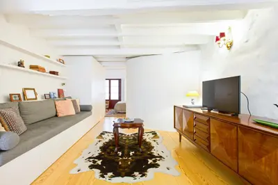 a living room with a couch and a tv at Porto Emotions - Caldeireiros in Porto