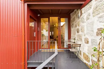 an entrance to a building with a table and chairs at Porto Emotions - Caldeireiros in Porto