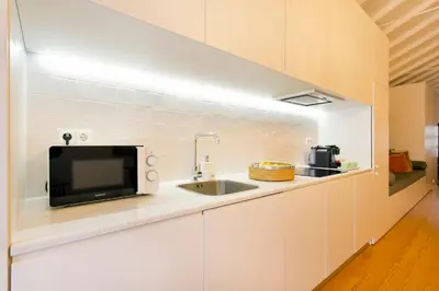 a kitchen with a sink and a tv on a counter at Porto Emotions - Caldeireiros in Porto