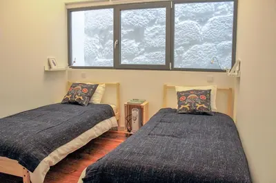 a bedroom with two beds in front of a window at Bonjardim Flats - T1 + 1 com terraço in Porto