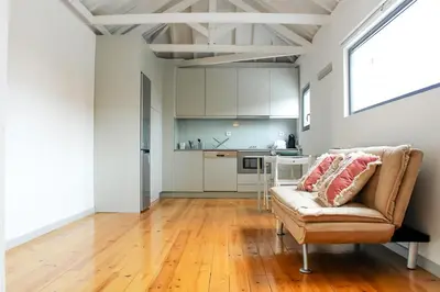 a living room with a couch and a kitchen at Bonjardim Flats - T1 + 1 com terraço in Porto