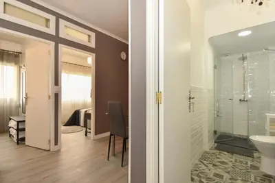 a bathroom with a shower and a toilet and a sink at Oporto Batalha Residence free parking in Porto