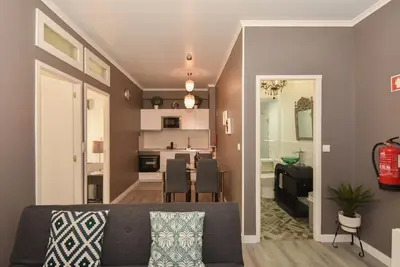 a living room with a couch and a dining room at Oporto Batalha Residence free parking in Porto