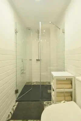 a bathroom with a glass shower and a toilet at Oporto Batalha Residence free parking in Porto