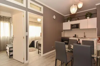 a dining room and living room with a table and chairs at Oporto Batalha Residence free parking in Porto