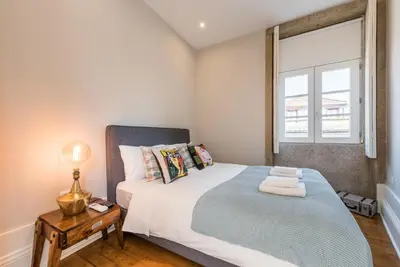 a bedroom with a large bed and a window at GuestReady - Chic retreat in the heart of Porto in Porto