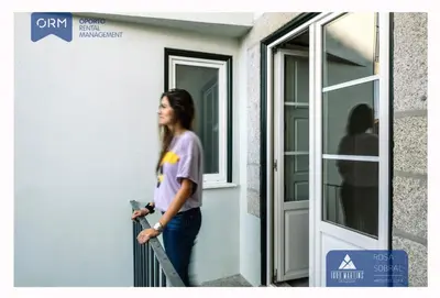a woman standing next to a door at ORM - 3 C´s Apartments in Porto