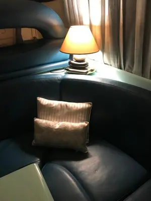 a lamp sitting next to a chair with a pillow at Porto Private Yacht- Accommodation Douro River in Porto