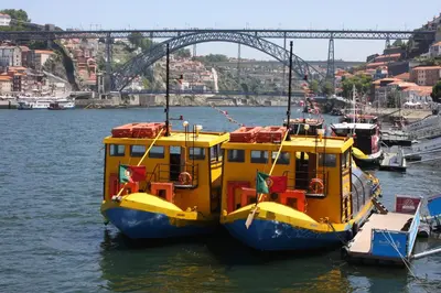a yellow and blue boat sitting in the water at Porto Private Yacht- Accommodation Douro River in Porto