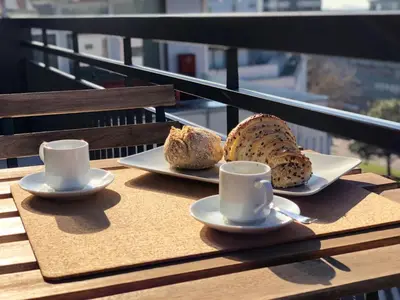 two plates of bread and cups on a table at Oporto up Town in Porto