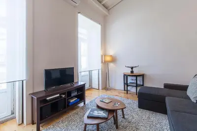 a living room with a couch and a tv at Oporto Mezzanine - by ML Apartments in Porto