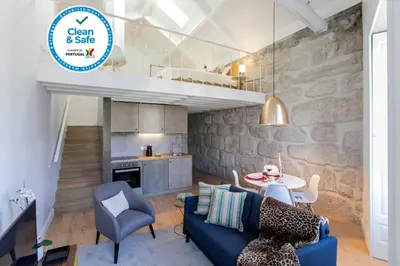 a living room with a blue couch and a table at Mouzinho Cosy LOFT in Porto