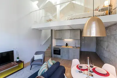a living room with a couch and a table at Mouzinho Cosy LOFT in Porto