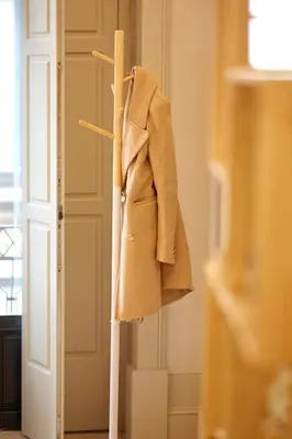 a coat hanging on a rack in a room at LOFT Sá de Noronha in Porto