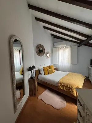 a bedroom with a large bed and a mirror at Red House- Historic center in Porto